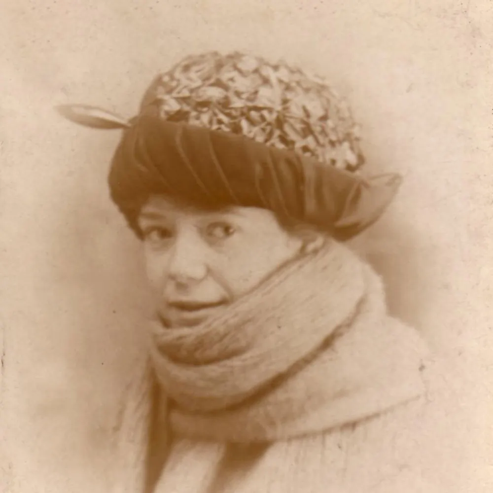 A portrait photograph of a girl in her early twenties. The image is a duotone photograph and is out of focus. It's shows with a sharp full colour restored version.